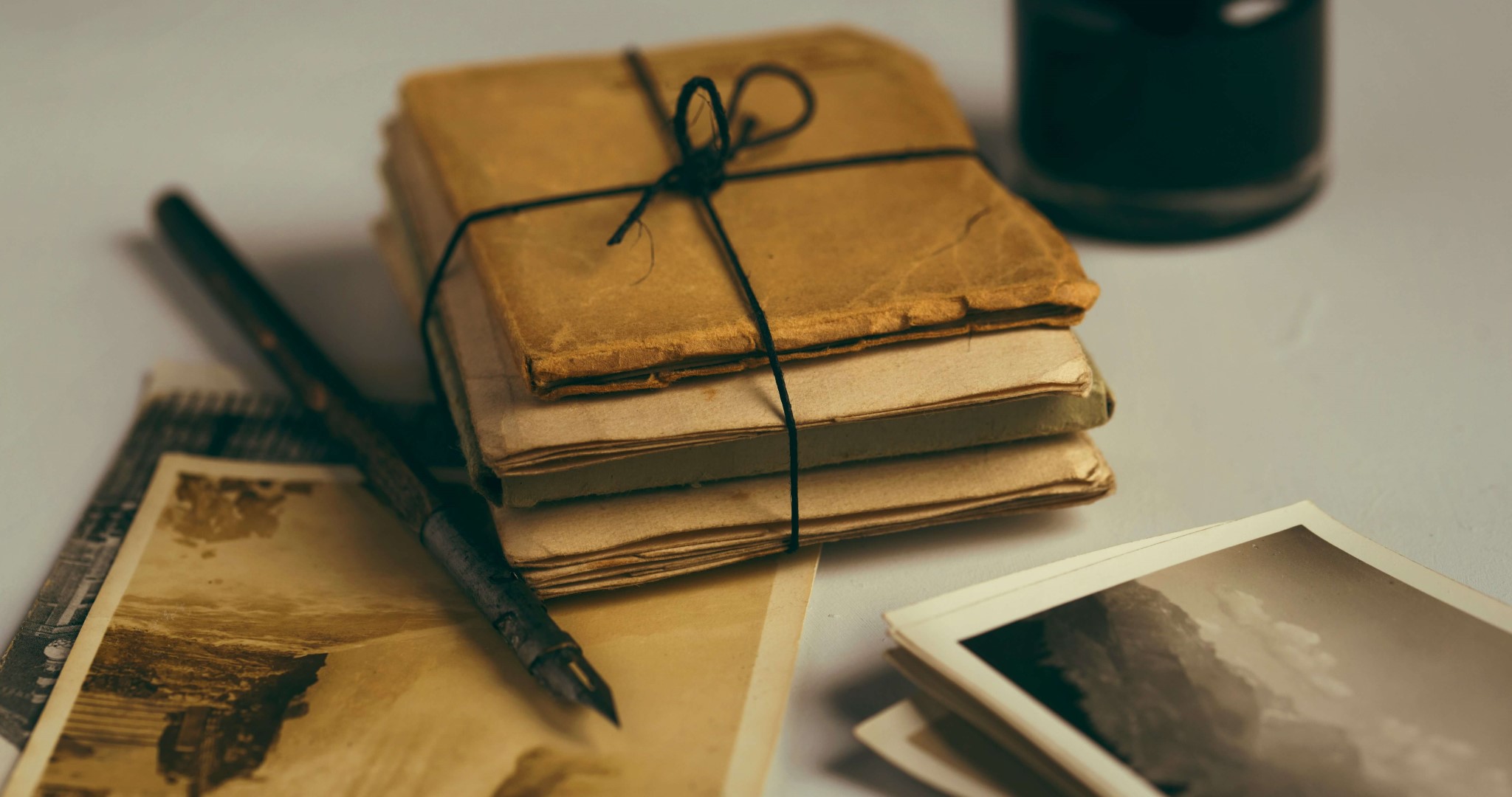 Group of letters with writing quill.